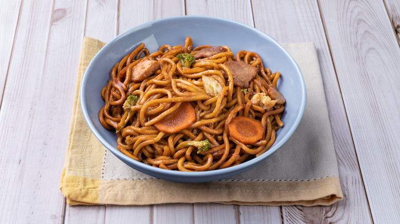A bowl of Yakisoba noodles in a blue bowl