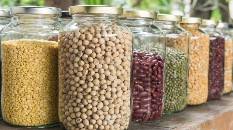 Various dry legumes in glass jars