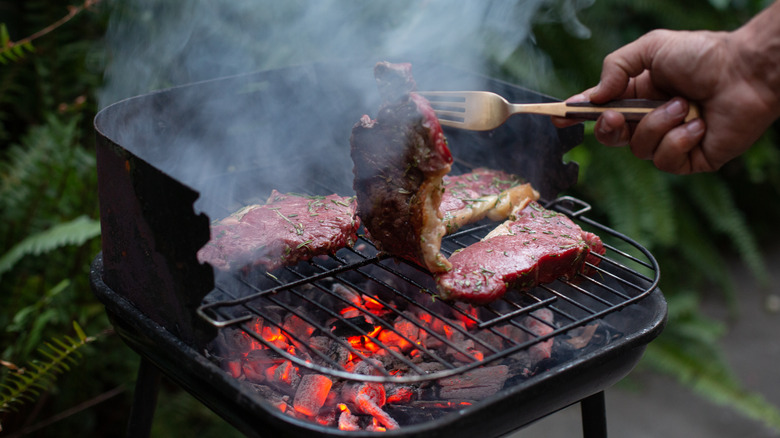 Man cooking on a charcoal grill