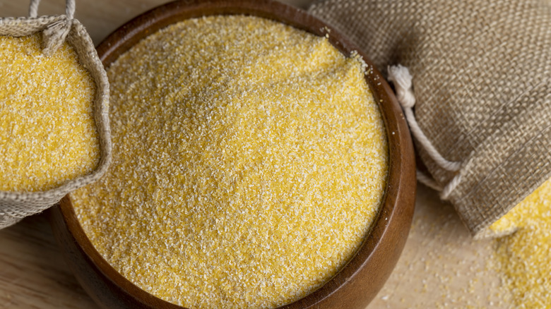 Wooden bowl of yellow cornmeal