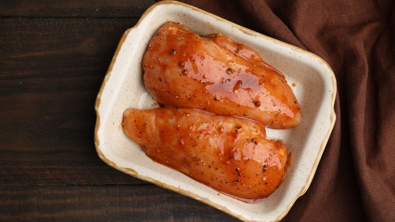 raw chicken marinating in sauce