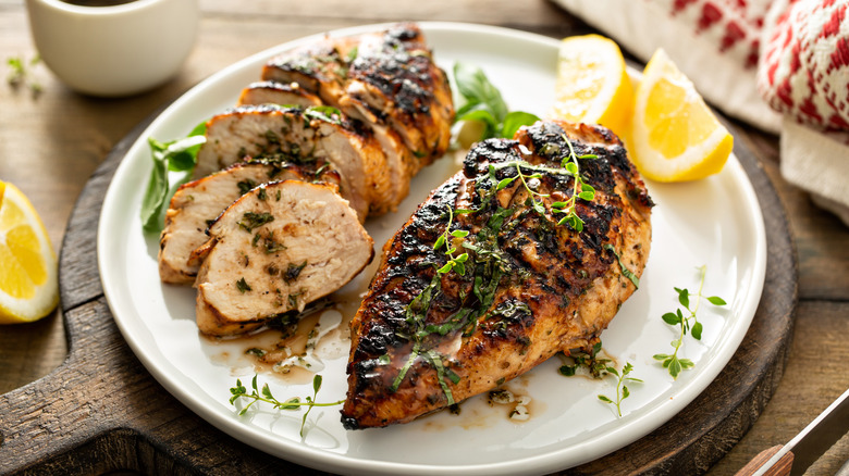 charred chicken breasts on plate with garnish