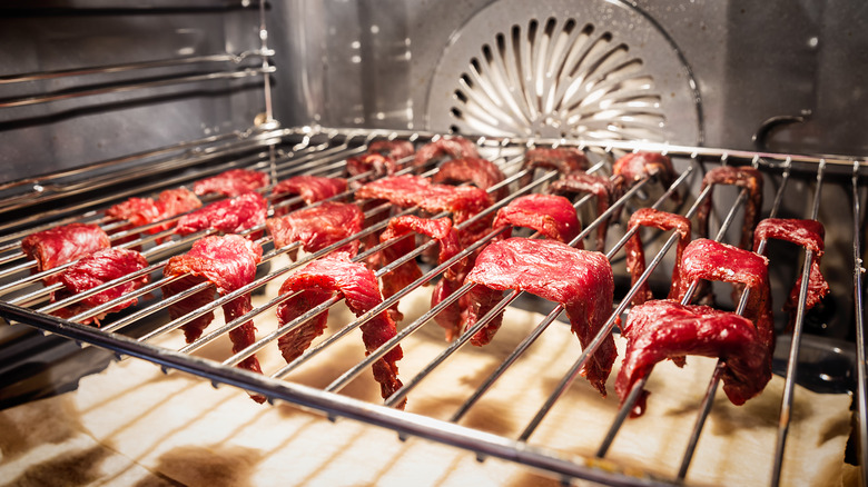 Beef strips cooking on an oven rack