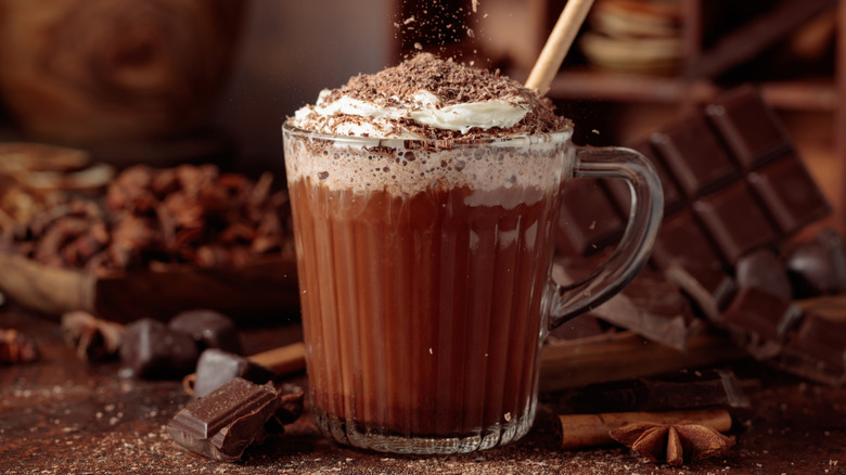 Hot chocolate topped with whipped cream and cocoa powder