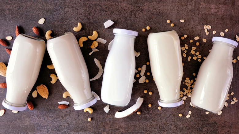 Bottles of nondairy milks and nuts and seeds