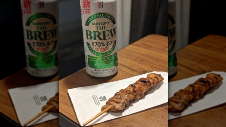 A 7-Eleven chicken yakitori skewer with a beer.