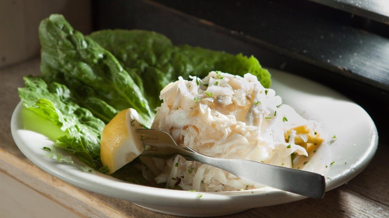 Plate of a scoop of West Indies salad with lemon slice and lettuce leaf from Felix's Fish Camp