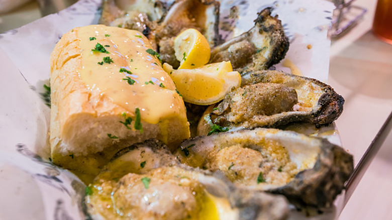 Chargrilled oysters with bread and lemon