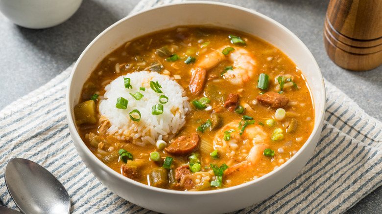 Bowl of seafood gumbo with scoop of white rice