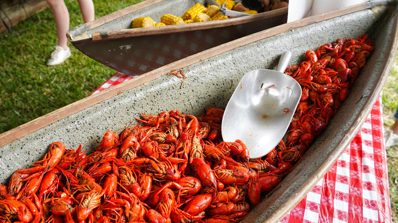 Boiled crawfish and corn in troughs