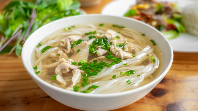 A white bowl of pho