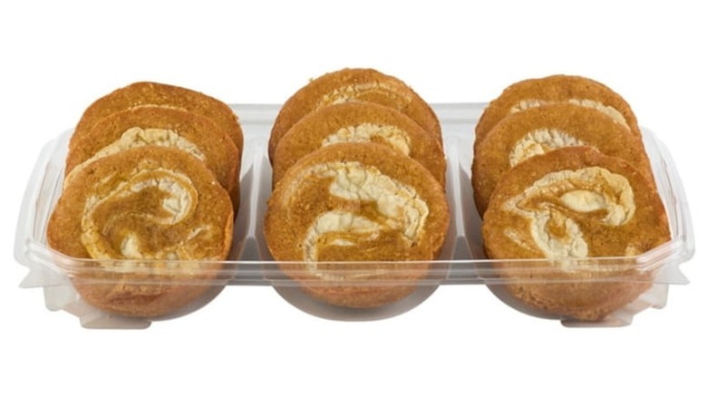 Nine orange and white pumpkin blondies in a clear plastic tray