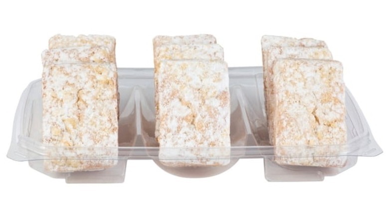 Rectangular-shaped, powdered sugar-coated baked goods in a clear plastic tray