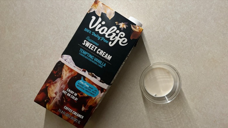 Violife Supreme Sweet Cream Vanilla Coffee Dairy-Free Creamer carton and creamer in glass ramekin on countertop