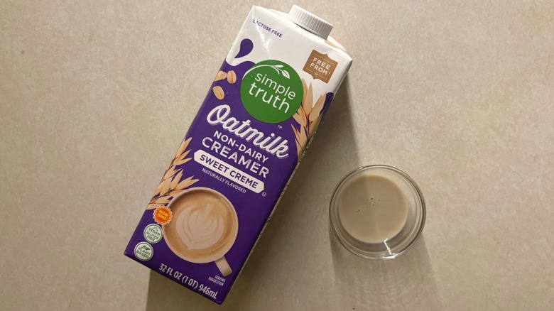 Simple Truth Sweet Cream Non-Dairy Oatmilk Coffee Creamer carton and creamer in glass ramekin on countertop