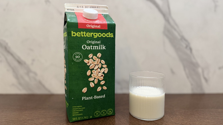 Glass and carton of bettergoods oat milk