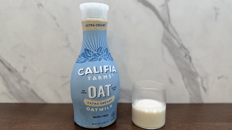Glass and bottle of Califia Farms oat milk