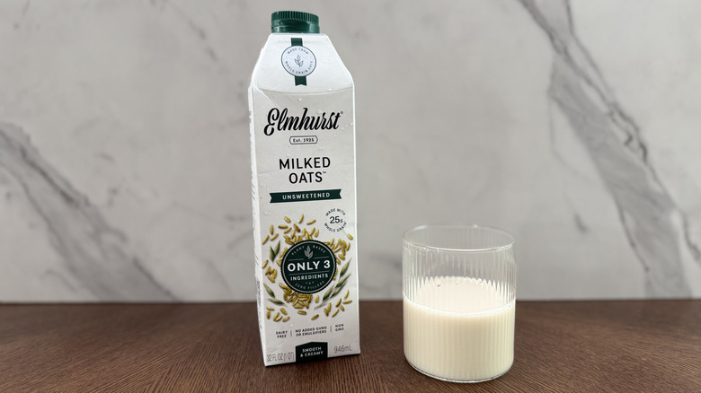 Glass and carton of Elmhurst oat milk