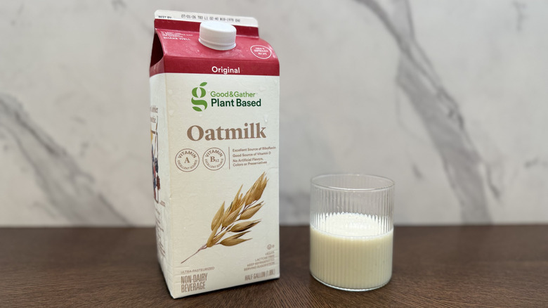 Glass and carton of Good & Gather oat milk