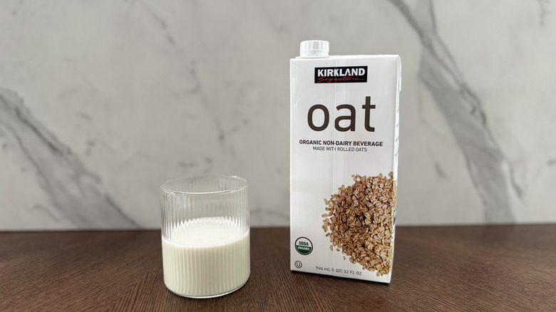 Glass and carton of Kirkland Signature oat milk