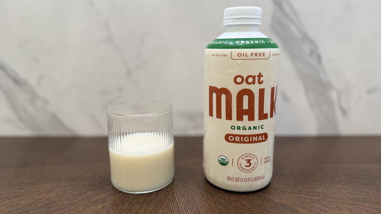 Glass and bottle of Malk oat milk