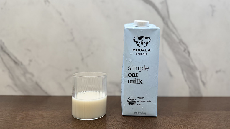 Glass and carton of Mooala oat milk