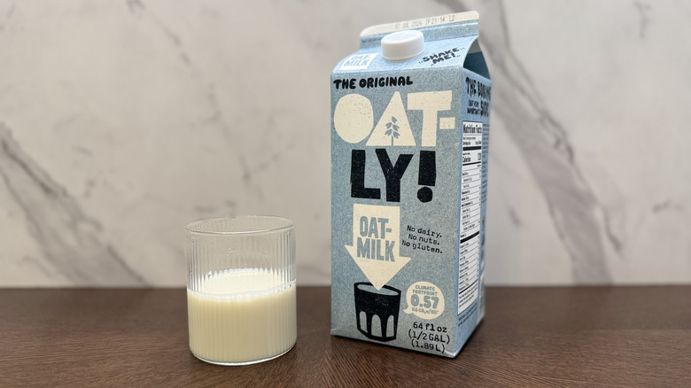 Glass and carton of Oatly oat milk