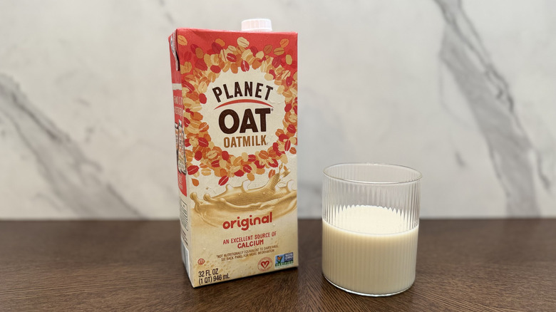 Glass and carton of Planet Oat oat milk