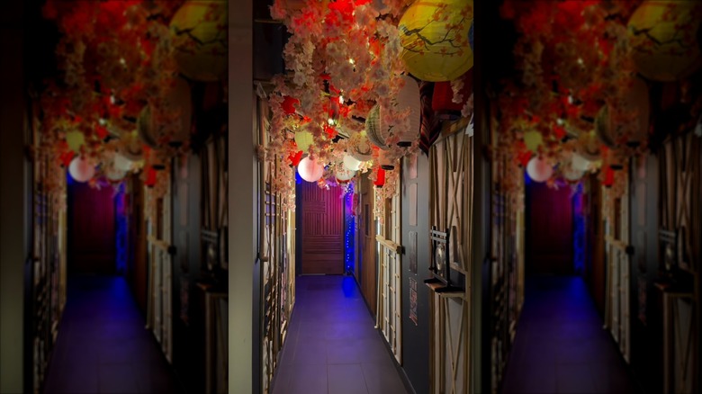 Interior of Sip & Skewer restaurant with hanging lanterns in Houston, TX
