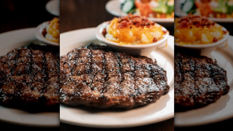 Steak from Logan's Roadhouse served with loaded mashed potatoes.