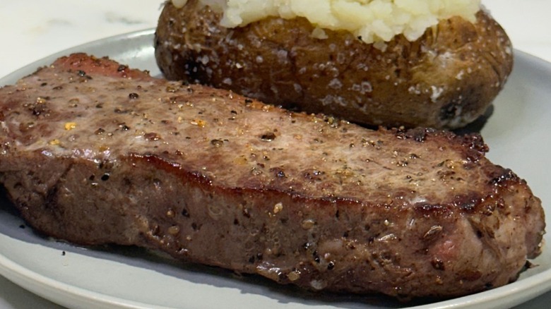 One of Ruby Tuesday's steak served with a baked potato.