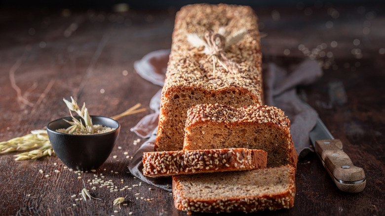 Sliced loaf of seeded graham bread