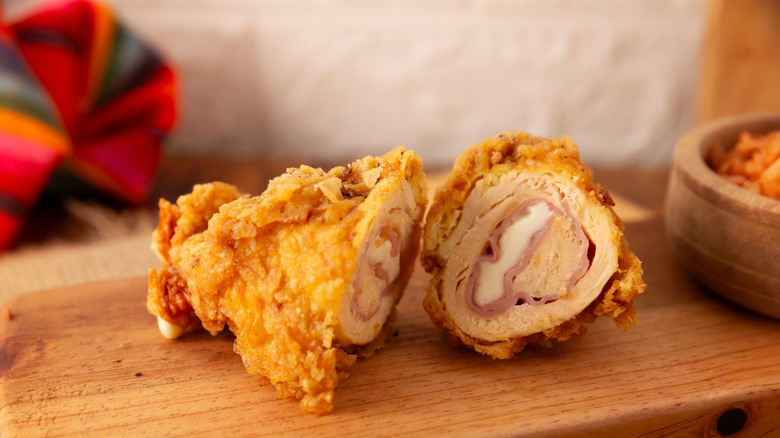 Chicken cordon bleu on a wood board