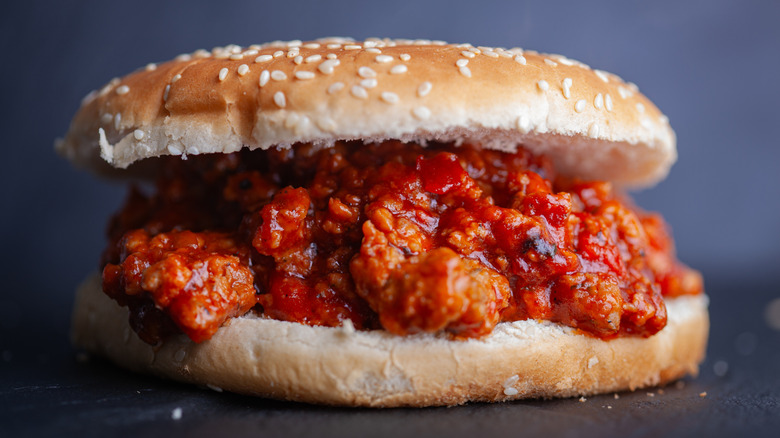 Chopped sloppy Joes meat on a sesame seed bun