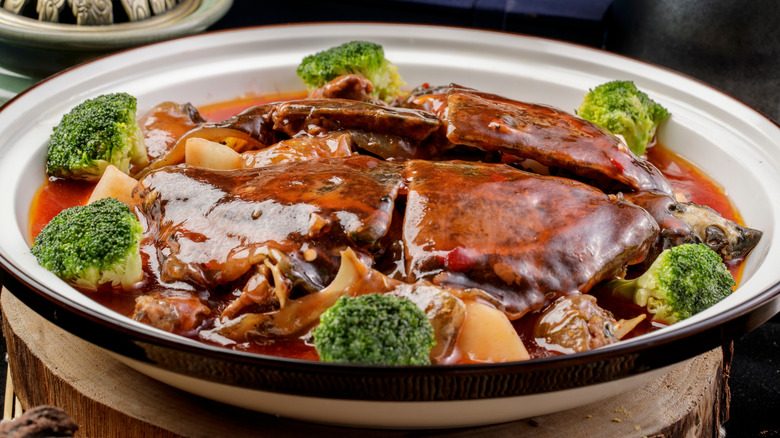 A bowl of turtle soup and broccoli