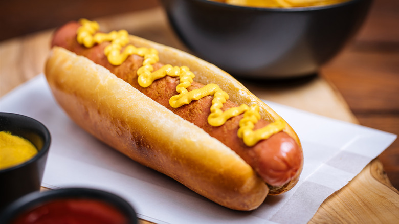 A hot dog with mustard on it