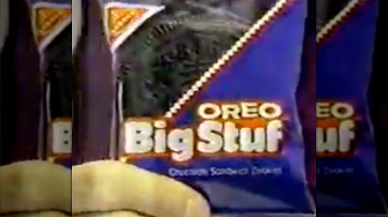 A screen shot from a commercial featuring a hand holding an Oreo Big Stuf in its packaging