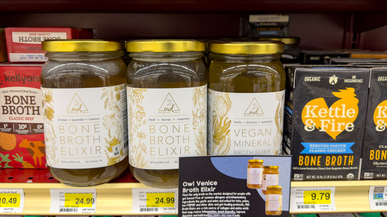 Jars and cartons of bone broth on grocery store shelf