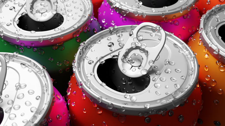 Close up of colorful beverage cans with tabs popped open