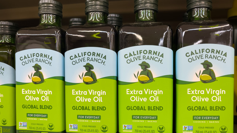four bottles of california olive ranch bottles on a shelf at the grocery store