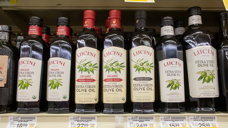 several bottles of lucini olive oil on display at the grocery store