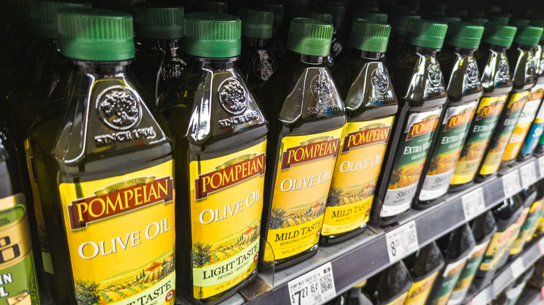 a row of pompeian olive oil bottles on display at the store