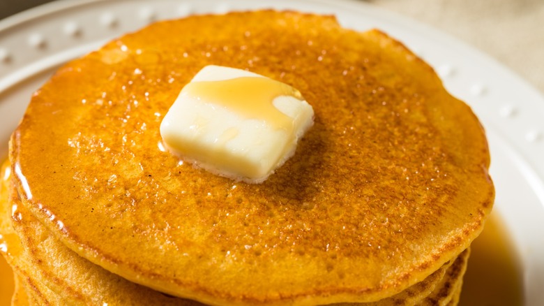 Homemade cornmeal Johnny cakes with butter and syrup
