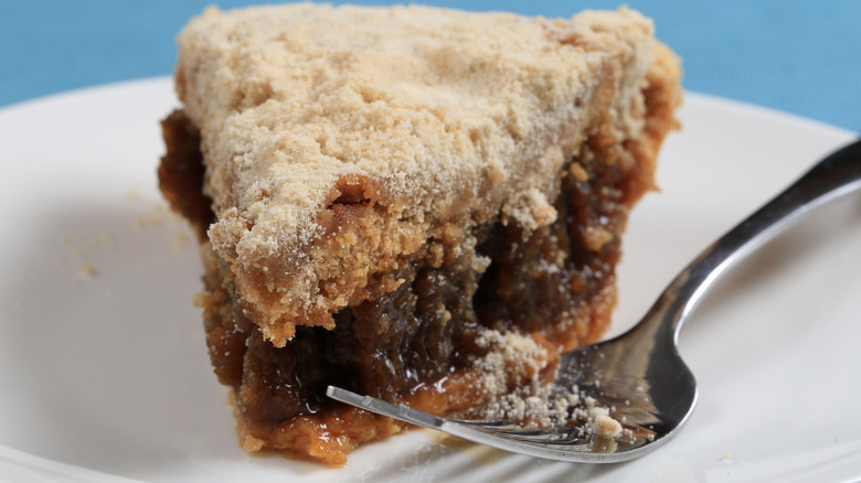 Slice of shoofly pie on a plate with a fork
