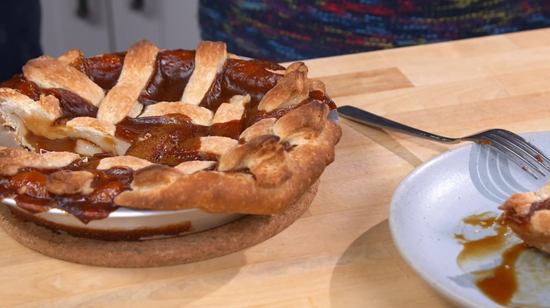 Whole vinegar pie beside a slice of vinegar pie with a fork on a plate