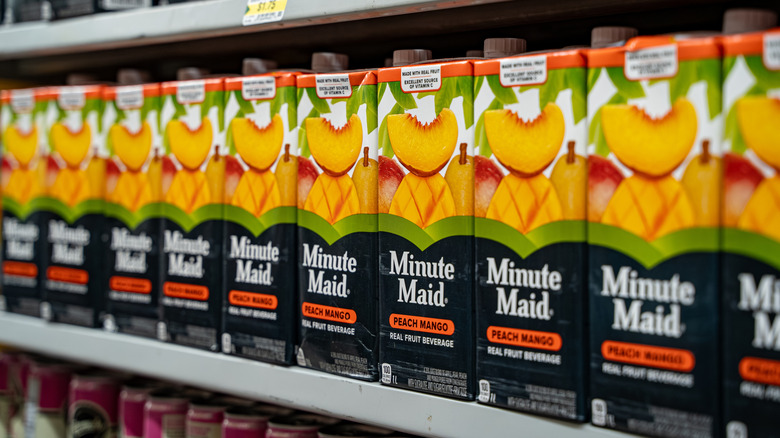 A row of Minute Maid Peach Mango fruit drinks at a grocery store