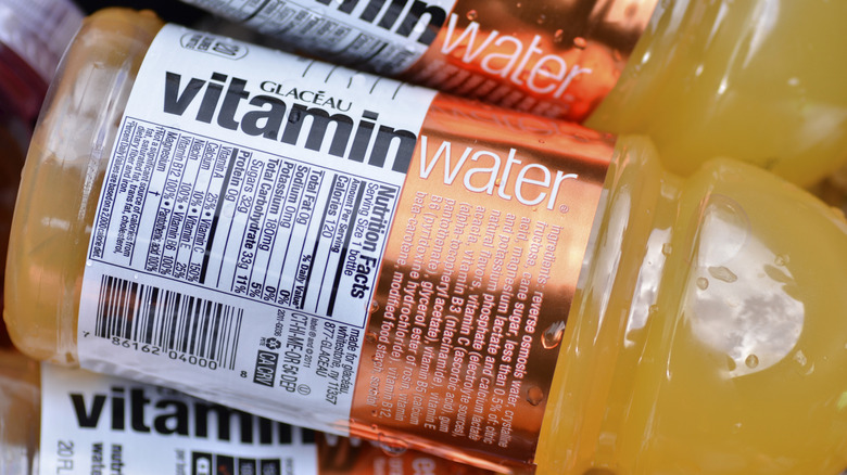 A close-up of a bottle of Vitaminwater on top of a pile of other bottles