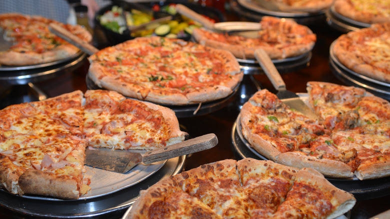 a buffet of different types of pizza