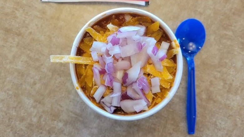 Culver's George's Chili in a to-go bowl topped with cheese and diced onions.