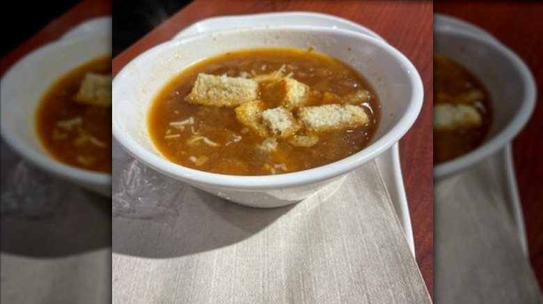 A bowl of the Panera Bread Bistro French Onion Soup sitting on a table.